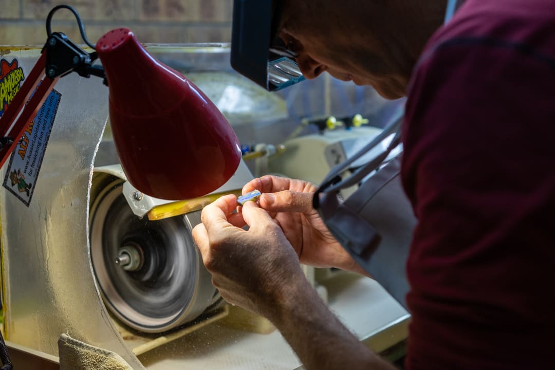 Andrew works on cutting and polishing an opal stone