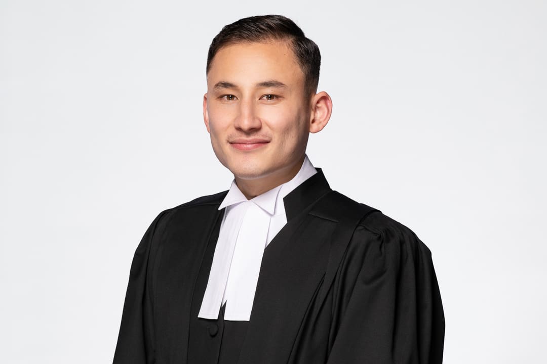 Melbourne barrister headshot of man wearing his formal robes, smiling to camera confidently.