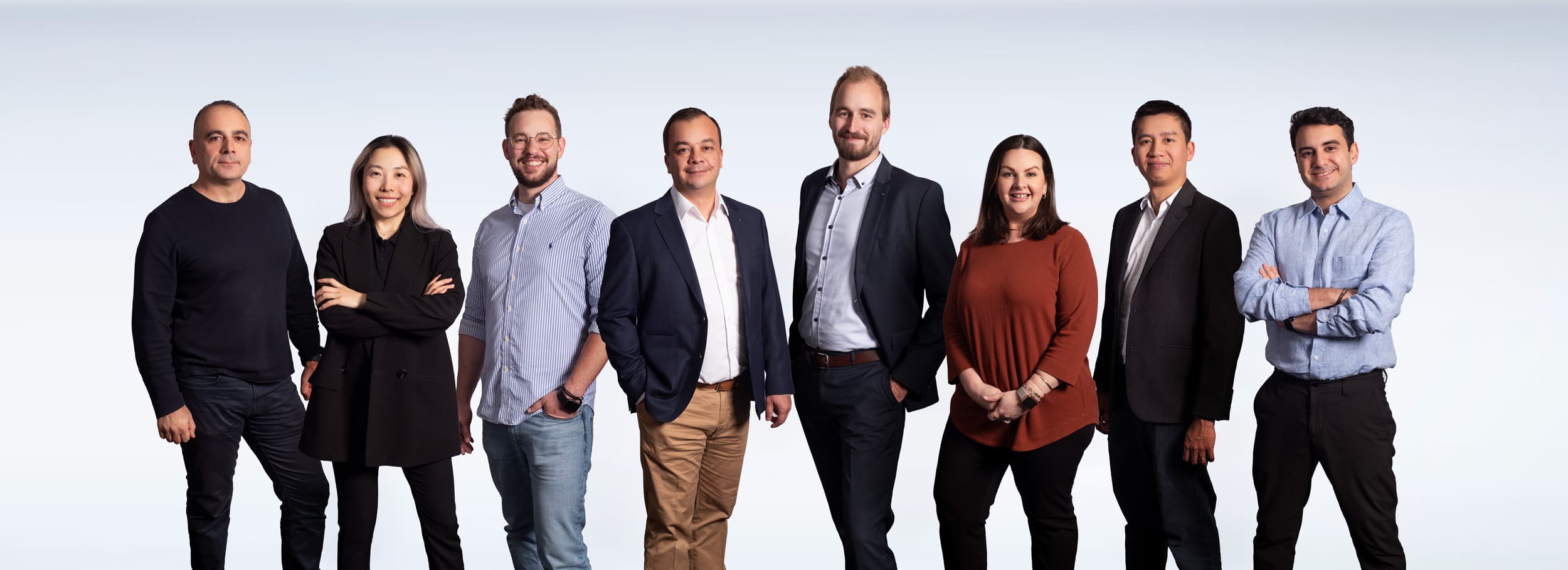 Composite group portrait on gradient background.