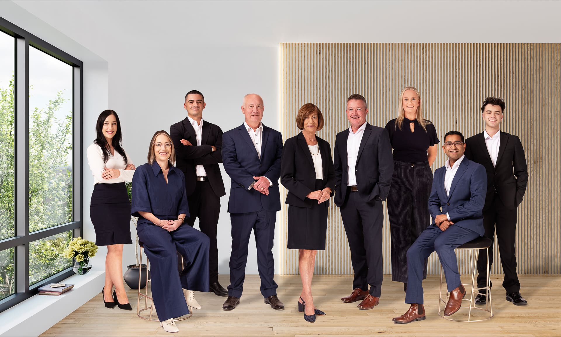 Composite full-length team photograph of 9 people.