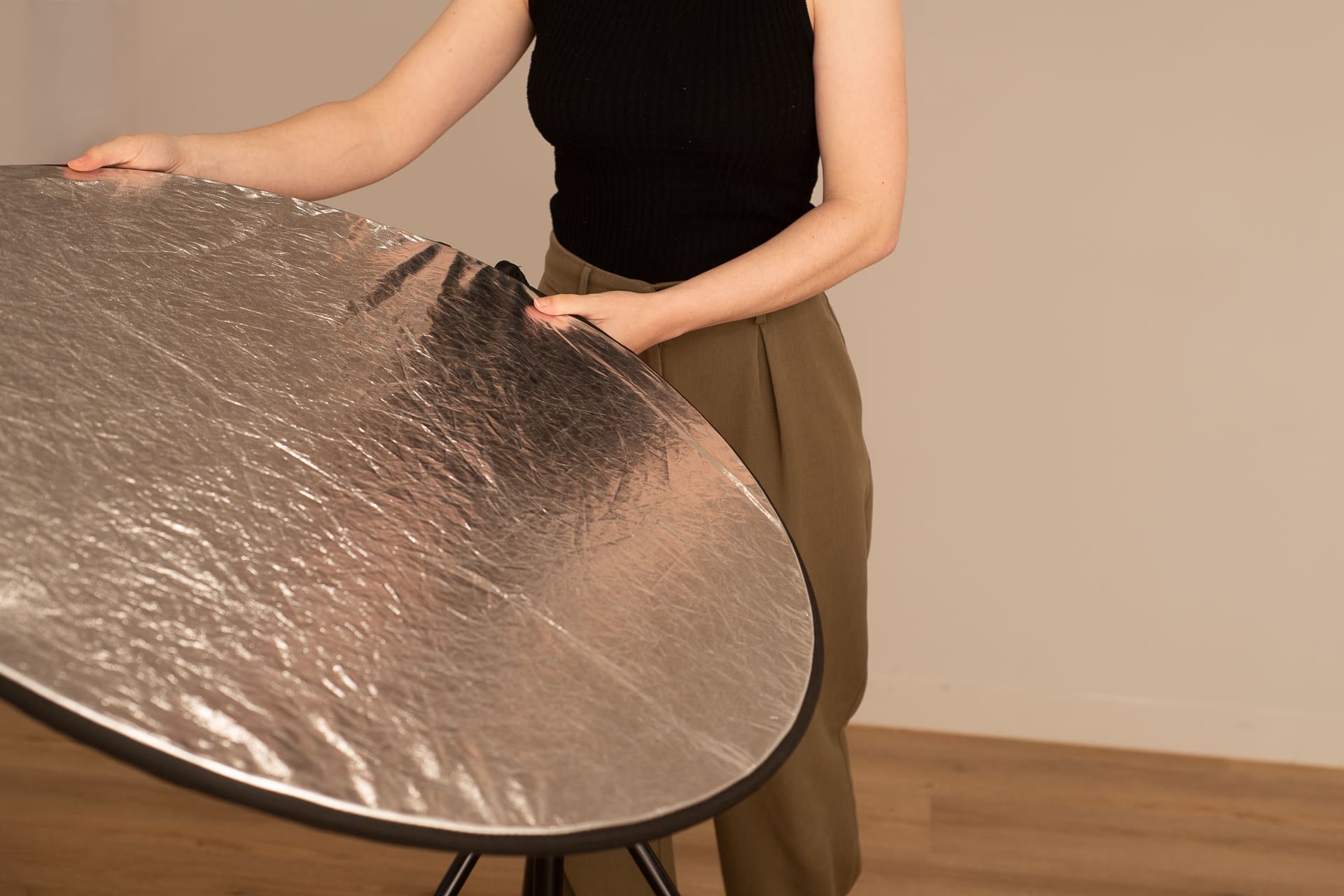 Julia's arms and hands interacting with a reflector in the studio.