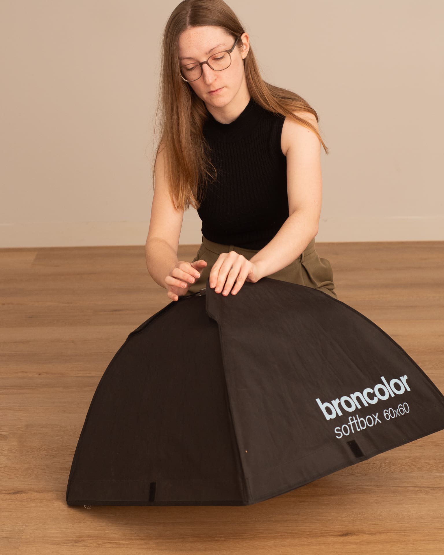 Julia sets up a softbox in her photography studio